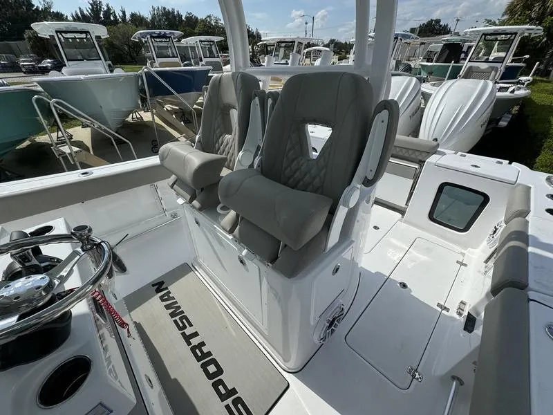 Slide: The Image of 2025 Sportsman Open 282 boat interior with dual seats and steering wheel. - 21
