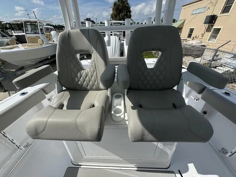 Slide: The Image of 2025 Sportsman Open 282 boat seats with armrests and cup holders. - 23