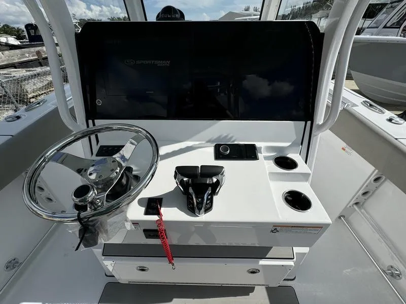 Slide: The Image of 2025 Sportsman Open 282 boat console with steering wheel and controls. - 25