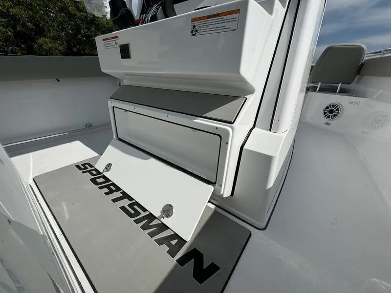 Slide: The Image of 2025 Sportsman Open 282 boat interior with branded flooring and storage compartment. - 27