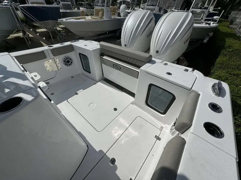Slide: The Image of 2025 Sportsman Open 282 boat interior with dual engines and seating area. - 29