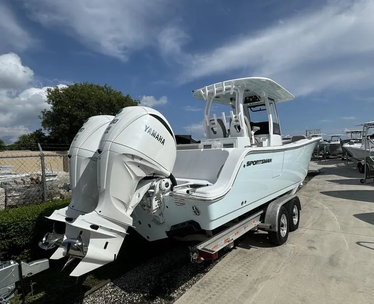 Slide: The Image of 2025 Sportsman Open 282 boat with Yamaha engine on trailer, under clear blue sky. - 3