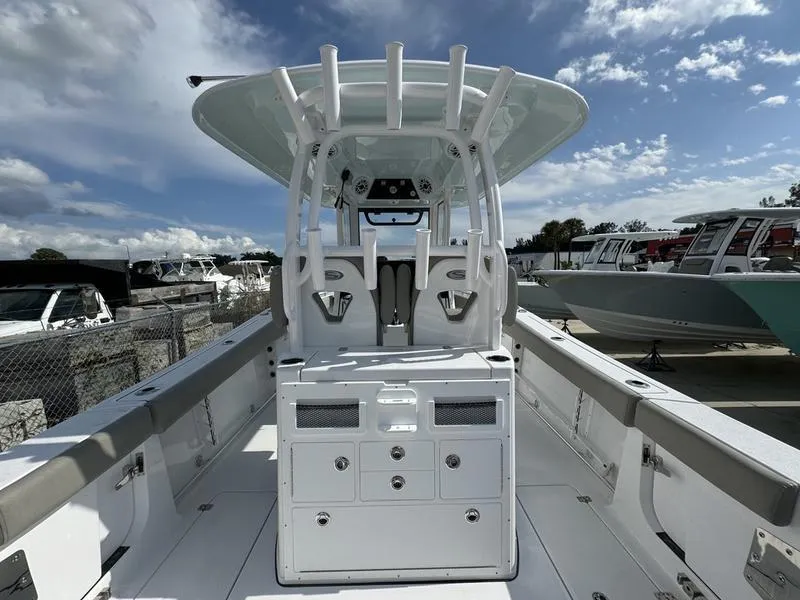 Slide: The Image of 2025 Sportsman Open 282 boat interior with helm station and seating under a blue sky. - 31