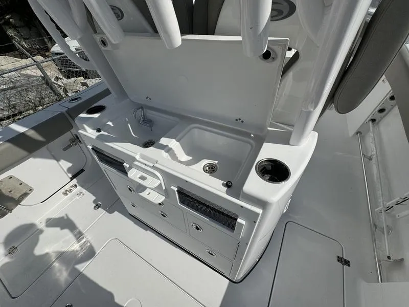 Slide: The Image of 2025 Sportsman Open 282 boat interior with sink and storage compartments. - 32