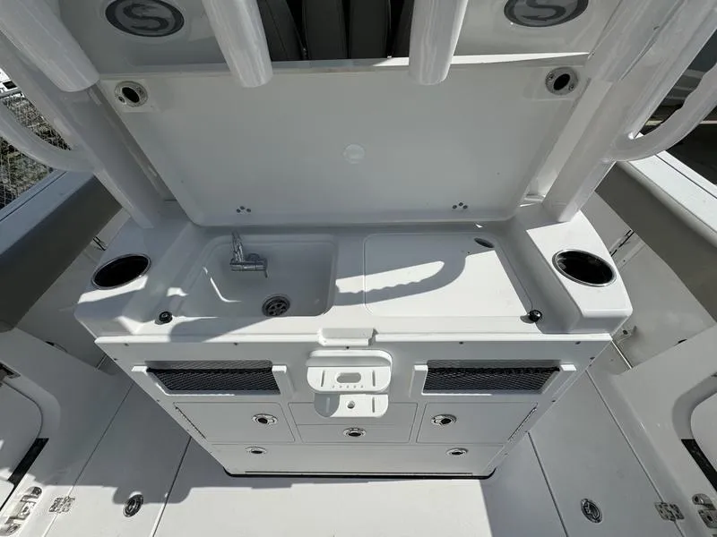 Slide: The Image of 2025 Sportsman Open 282 boat console with sink and storage compartments. - 33