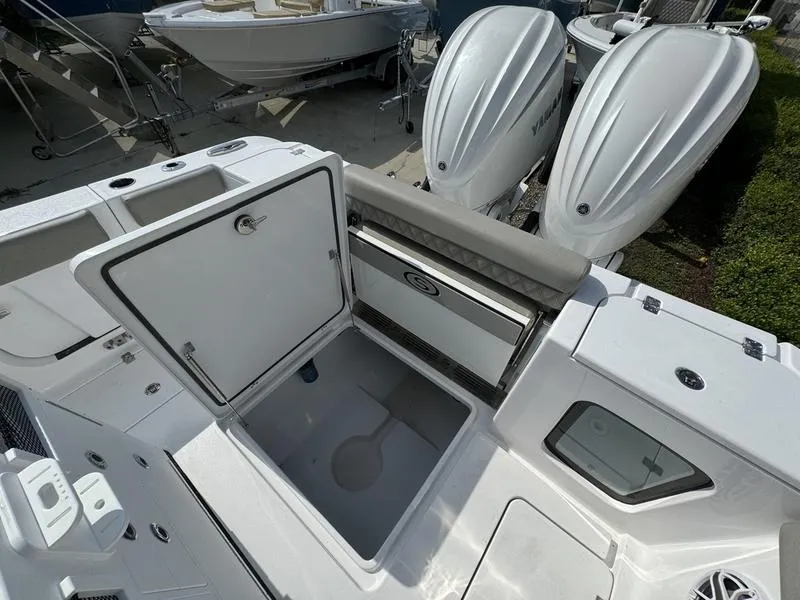 Slide: The Image of 2025 Sportsman Open 282 boat with open storage compartment and dual engines. - 34