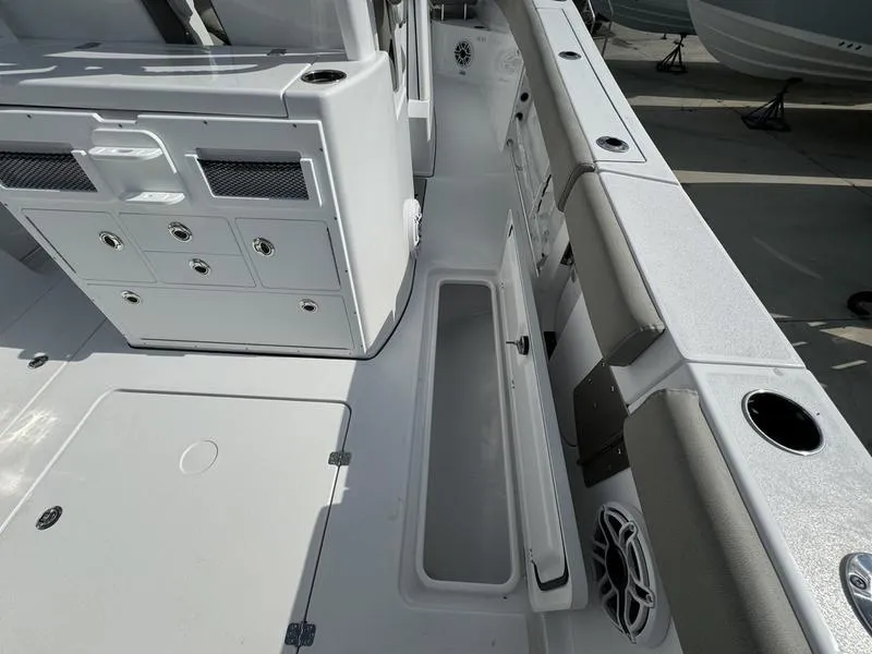 Slide: The Image of 2025 Sportsman Open 282 boat interior with storage compartments and seating. - 36
