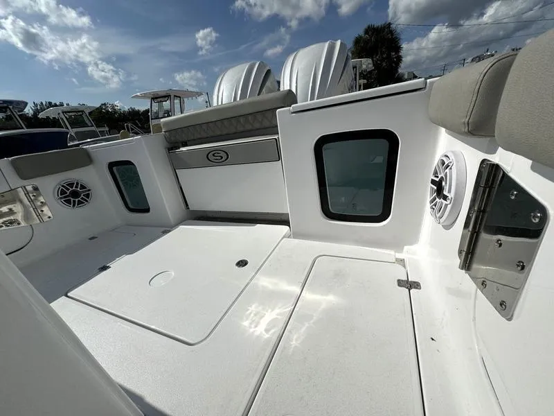 Slide: The Image of 2025 Sportsman Open 282 boat deck with seating and storage compartments. - 38