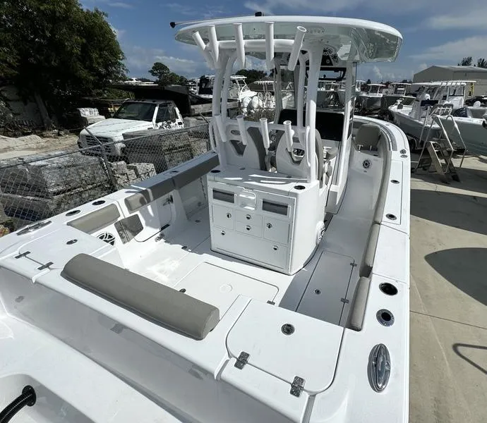 Slide: The Image of 2025 Sportsman Open 282 boat, spacious deck, modern design, docked outdoors. - 5