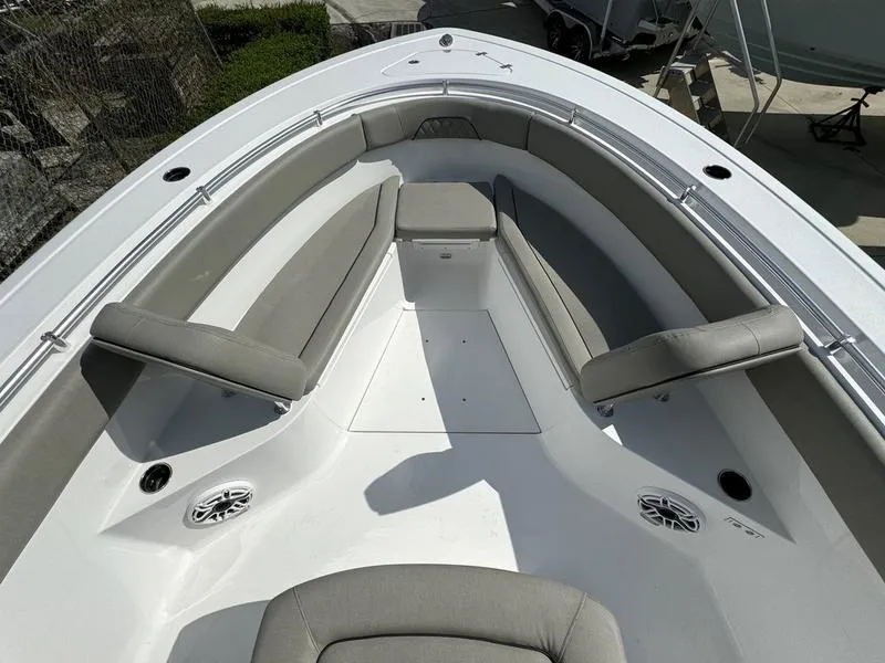 Slide: The Image of 2025 Sportsman Open 282 boat interior with cushioned seating and speakers. - 6