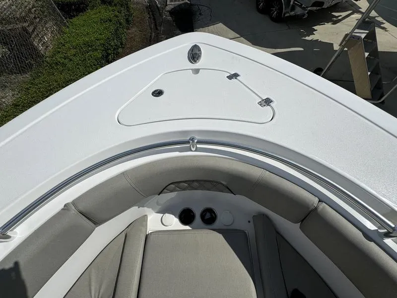 Slide: The Image of 2025 Sportsman Open 282 boat bow with cushioned seating and storage compartment. - 7