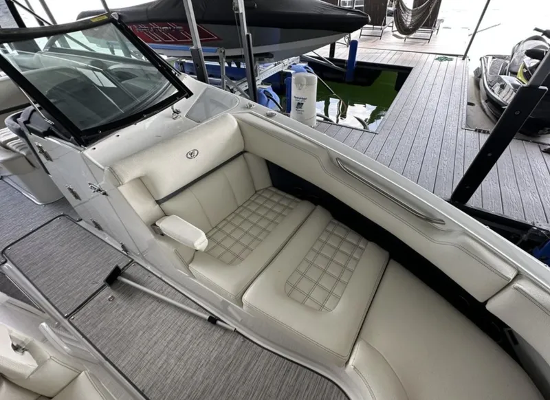 Slide: The Image of 2022 Cobalt R30 boat interior with white cushioned seating at a dock. - 11