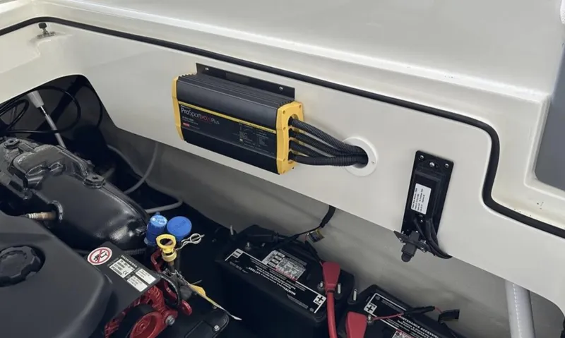 Slide: The Image of 2022 Cobalt R30 boat engine compartment with battery charger and wiring. - 17