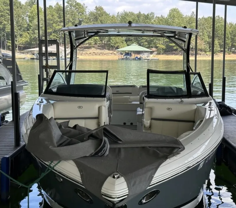 Slide: The Image of 2022 Cobalt R30 boat docked on a serene lake with lush greenery. - 21