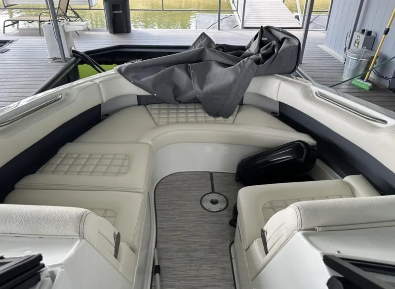 Slide: The Image of 2022 Cobalt R30 boat interior with white seating and gray flooring. - 9
