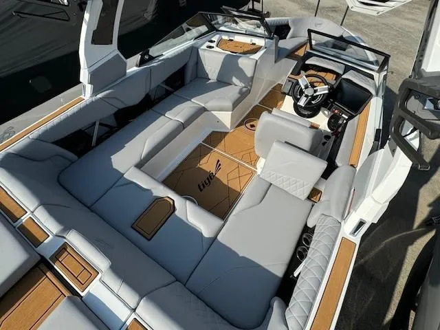 Slide: The Image of 2025 Tigé Z1 boat interior with luxurious gray seating and stylish wood accents. - 10