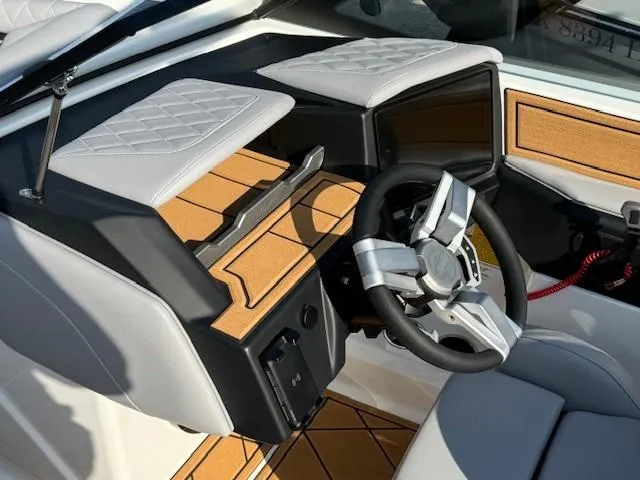Slide: The Image of 2025 Tigé Z1 boat interior with gray seating and wood accents. - 11