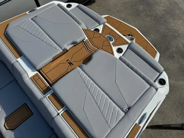 Slide: The Image of 2025 Tigé Z1 boat interior with luxurious gray seating and stylish wood accents. - 9