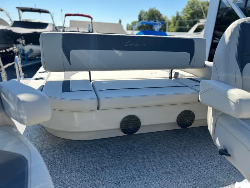 Slide: The Image of 2024 Barletta A20UC boat interior with plush seating and cup holders. - 16