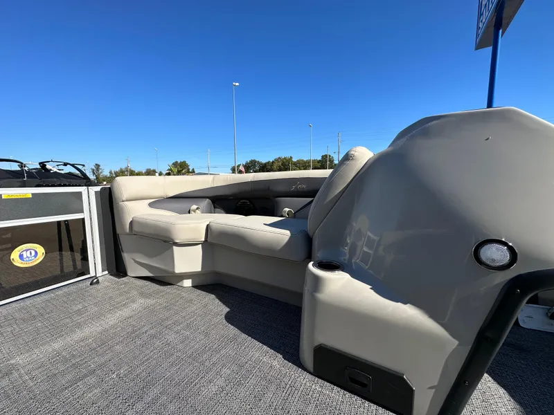 Slide: The Image of 2024 Barletta A20UC pontoon boat interior with plush seating under clear blue sky. - 18