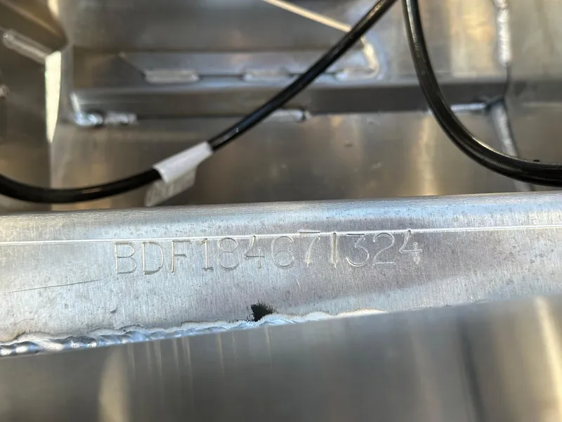 Slide: The Image of 2024 Barletta A20UC boat hull identification number engraved on metal surface. - 28
