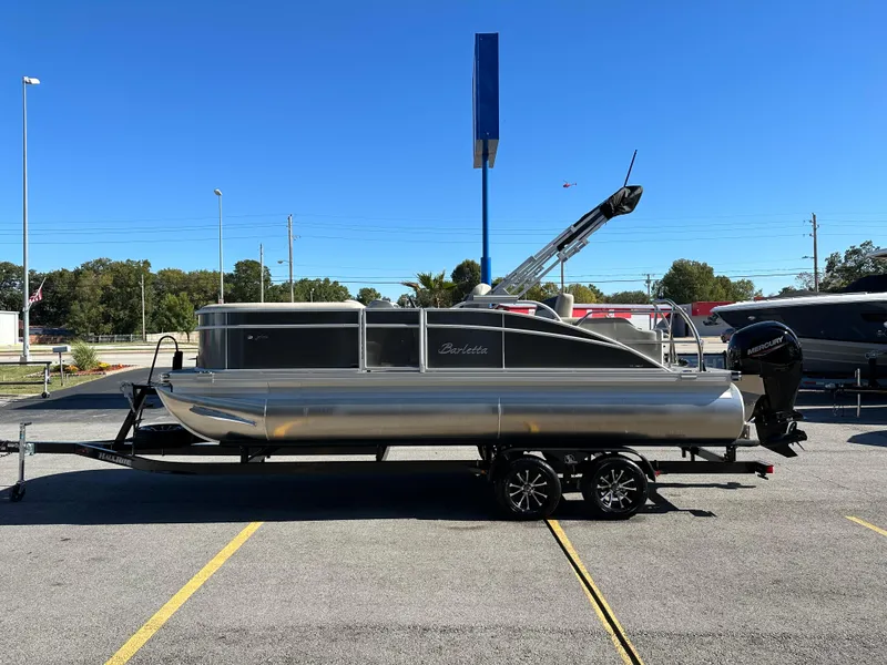 Slide: The Image of 2024 Barletta A20UC pontoon boat on trailer in parking lot. - 6