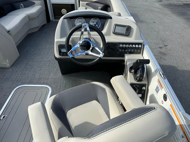 Slide: The Image of 2024 Barletta A22UC boat cockpit with steering wheel and control panel. - 15