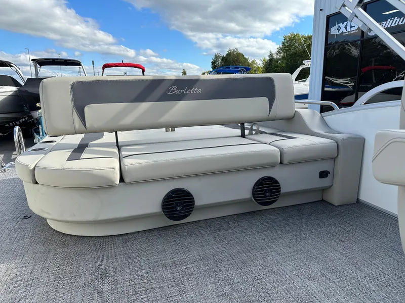 Slide: The Image of 2024 Barletta A22UC boat interior with cushioned seating and speaker system. - 16