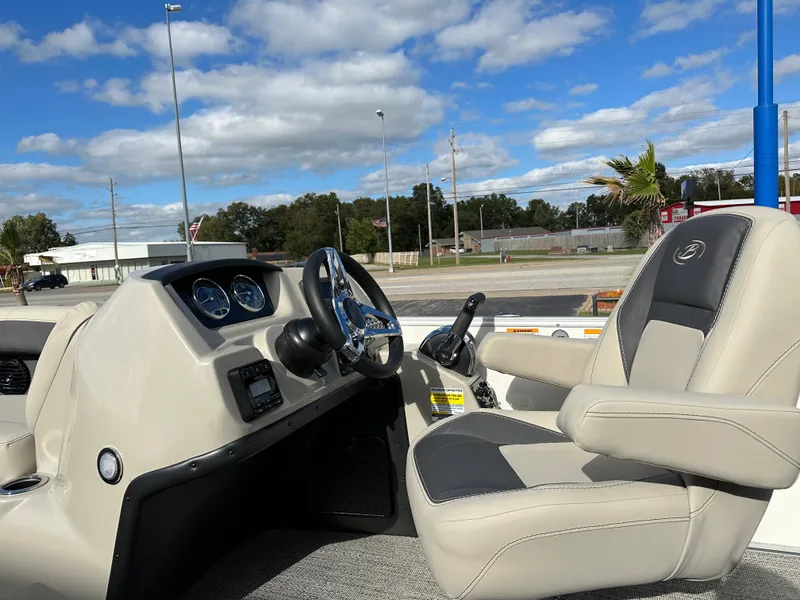 Slide: The Image of 2024 Barletta A22UC boat interior with steering wheel and captain's chair. - 17