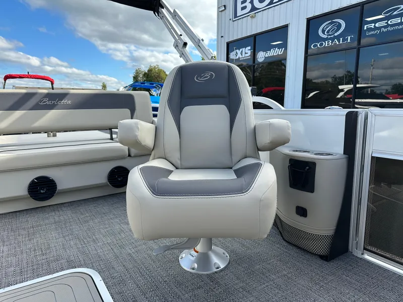 Slide: The Image of 2024 Barletta A22UC boat seat with armrests, gray upholstery, and outdoor setting. - 18