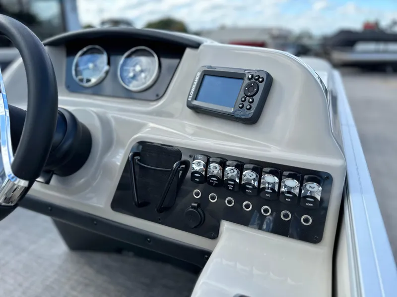 Slide: The Image of 2024 Barletta A22UC boat dashboard with gauges and control panel. - 24