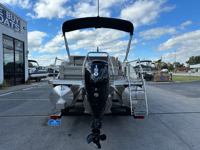 Slide: The Image of 2024 Barletta A22UC pontoon boat with 150 HP engine at dealership. - 4