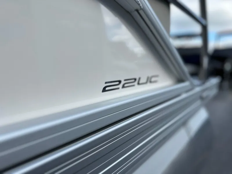 Slide: The Image of Close-up of 2024 Barletta A22UC boat model name on sleek exterior. - 9