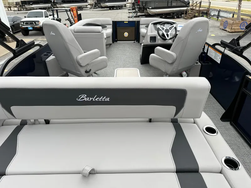 Slide: The Image of 2025 Barletta A22UC pontoon boat interior with gray seating and steering wheel. - 10