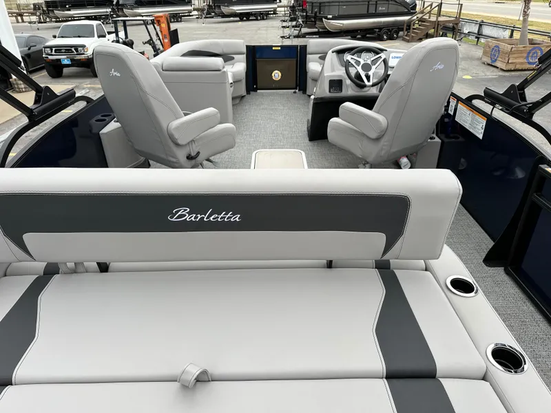 Slide: The Image of 2025 Barletta A22UC pontoon boat interior with gray seating and steering console. - 11