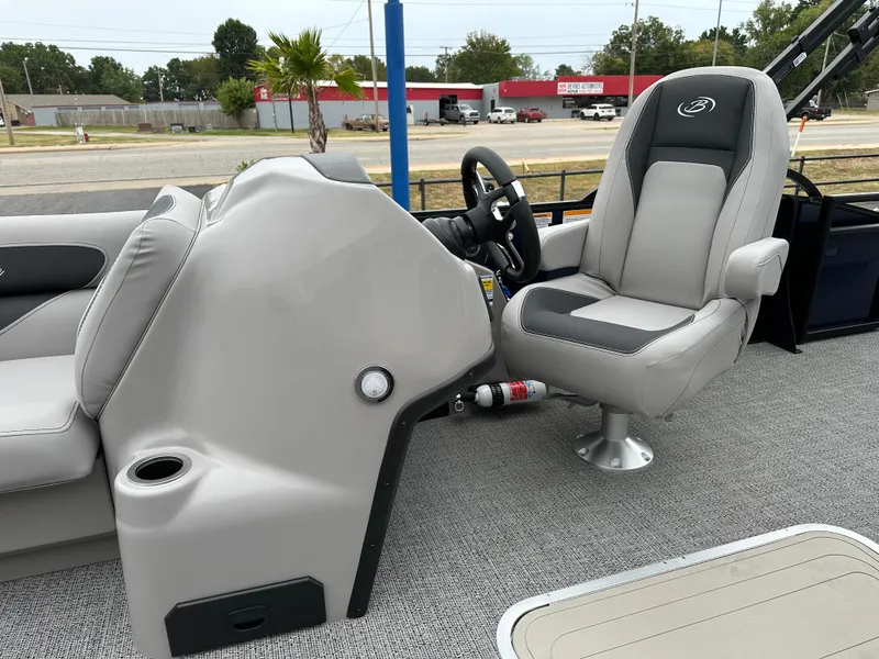 Slide: The Image of 2025 Barletta A22UC boat interior with captain's chair and steering console. - 15