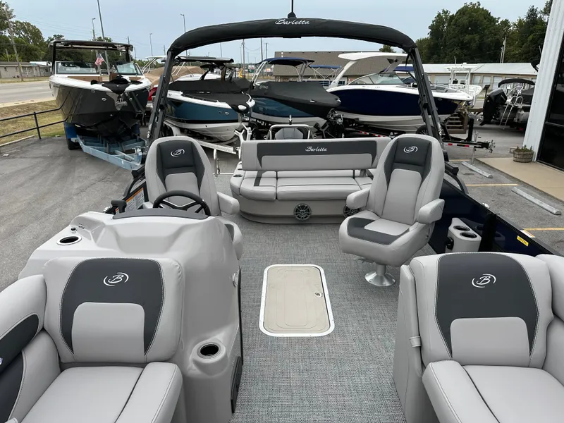 Slide: The Image of 2025 Barletta A22UC pontoon boat interior with gray seating and steering console. - 22