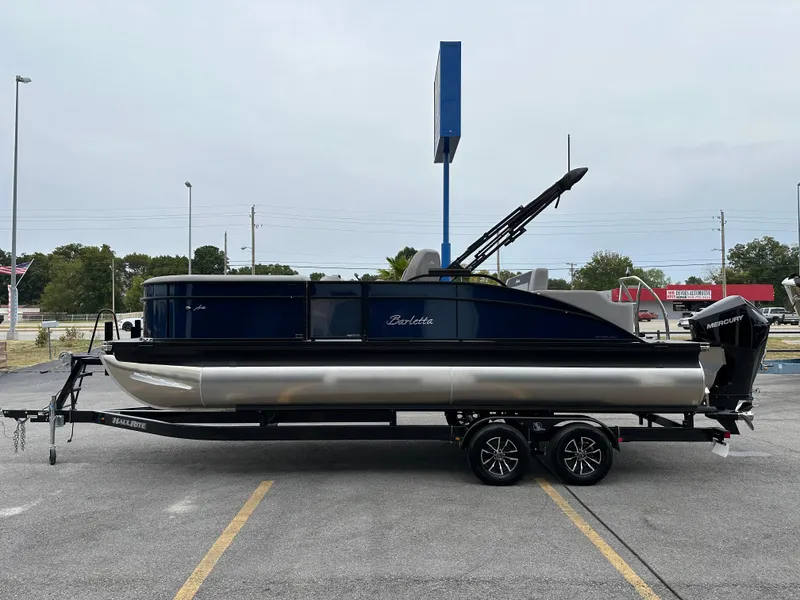 Slide: The Image of 2025 Barletta A22UC pontoon boat on trailer in parking lot. - 5