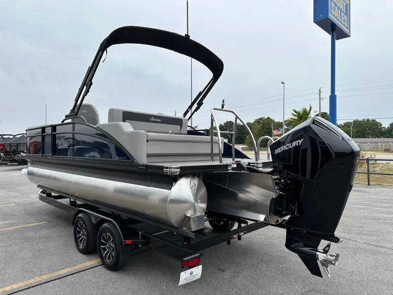 Slide: The Image of 2025 Barletta A22UC pontoon boat with Mercury engine on trailer in parking lot. - 6
