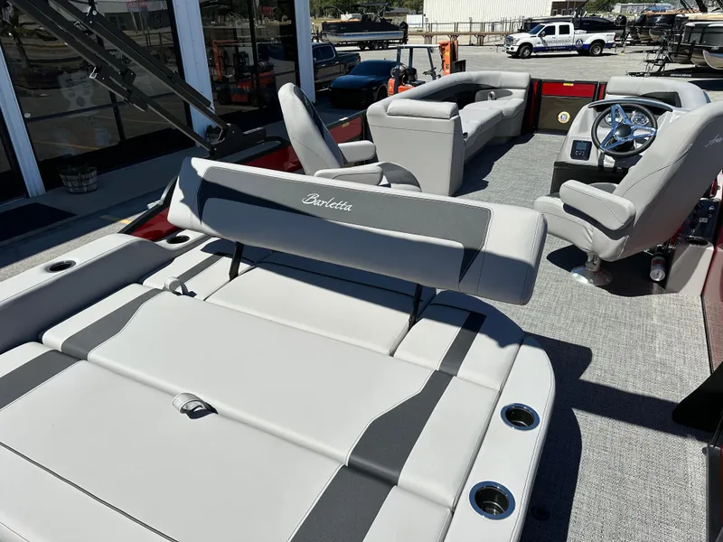 Slide: The Image of 2025 Barletta A24UC boat interior with plush seating and modern steering console. - 10