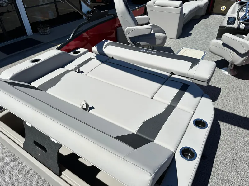 Slide: The Image of 2025 Barletta A24UC boat interior with luxurious seating and cup holders. - 11