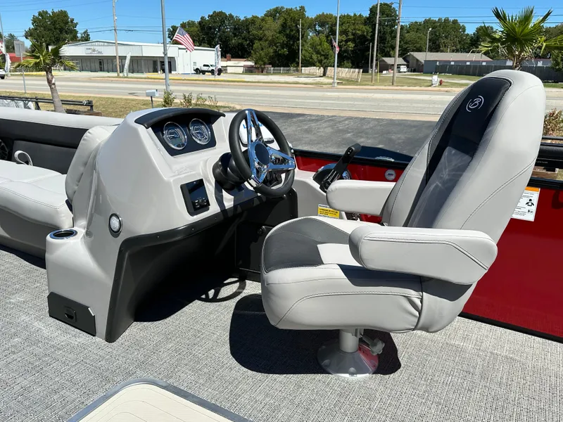 Slide: The Image of 2025 Barletta A24UC boat interior with captain's chair and steering console. - 13