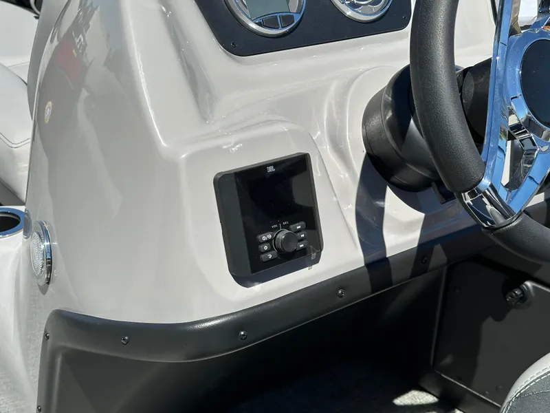 Slide: The Image of 2025 Barletta A24UC boat dashboard with steering wheel and control panel. - 18