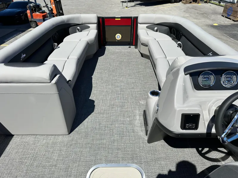 Slide: The Image of 2025 Barletta A24UC pontoon boat interior with plush seating and modern dashboard. - 19