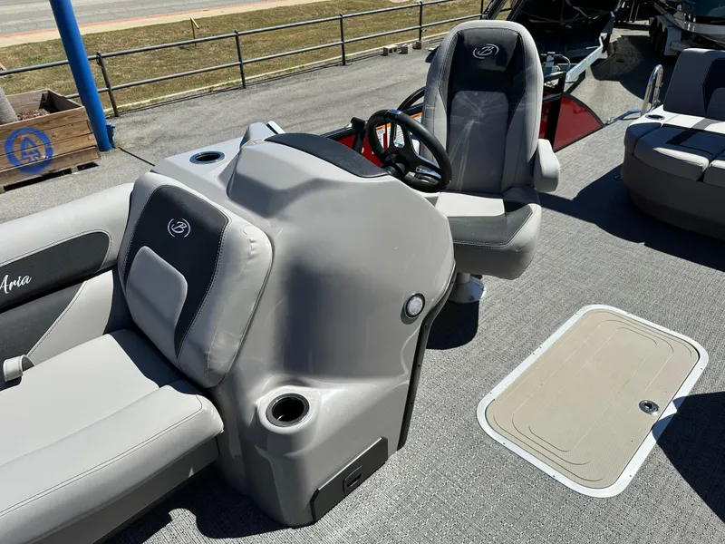 Slide: The Image of 2025 Barletta A24UC boat interior with steering console and seating. - 24