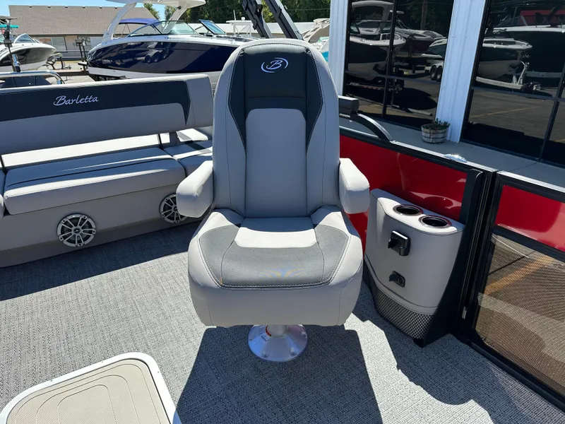 Slide: The Image of 2025 Barletta A24UC boat interior with captain's chair and seating area. - 25
