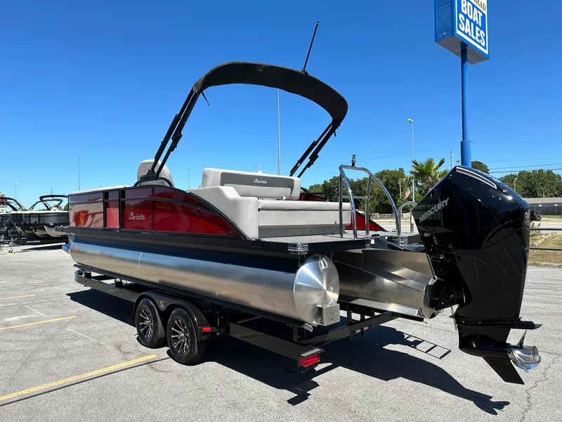 Slide: The Image of 2025 Barletta A24UC pontoon boat with Mercury engine in a boat sales lot. - 6