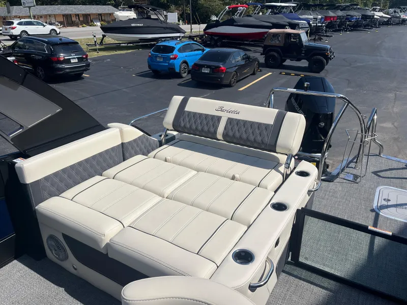 Slide: The Image of 2025 Barletta L25UEA boat with luxurious seating in a parking lot. - 12