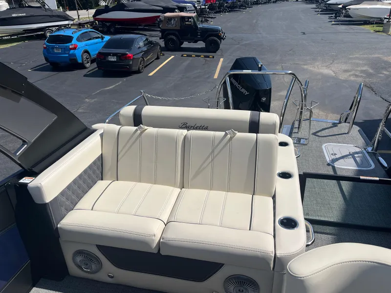Slide: The Image of 2025 Barletta L25UEA pontoon boat with luxurious seating and Mercury outboard motor. - 13