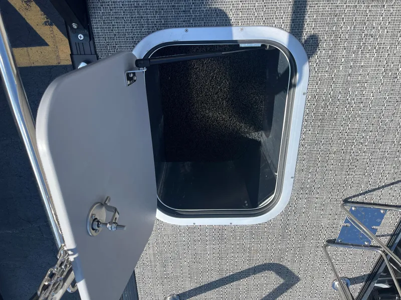 Slide: The Image of Open hatch on 2025 Barletta L25UEA boat deck, showing interior access. - 17